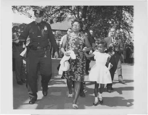 Protesting parent arrested -- Mrs. Eleanor Butler and her daughter Leonora, 6, are escorted by Lynbrook, Long Island, New York, police on Sept. 4 at the Davison Avenue School in Lynbrook after her arrest.